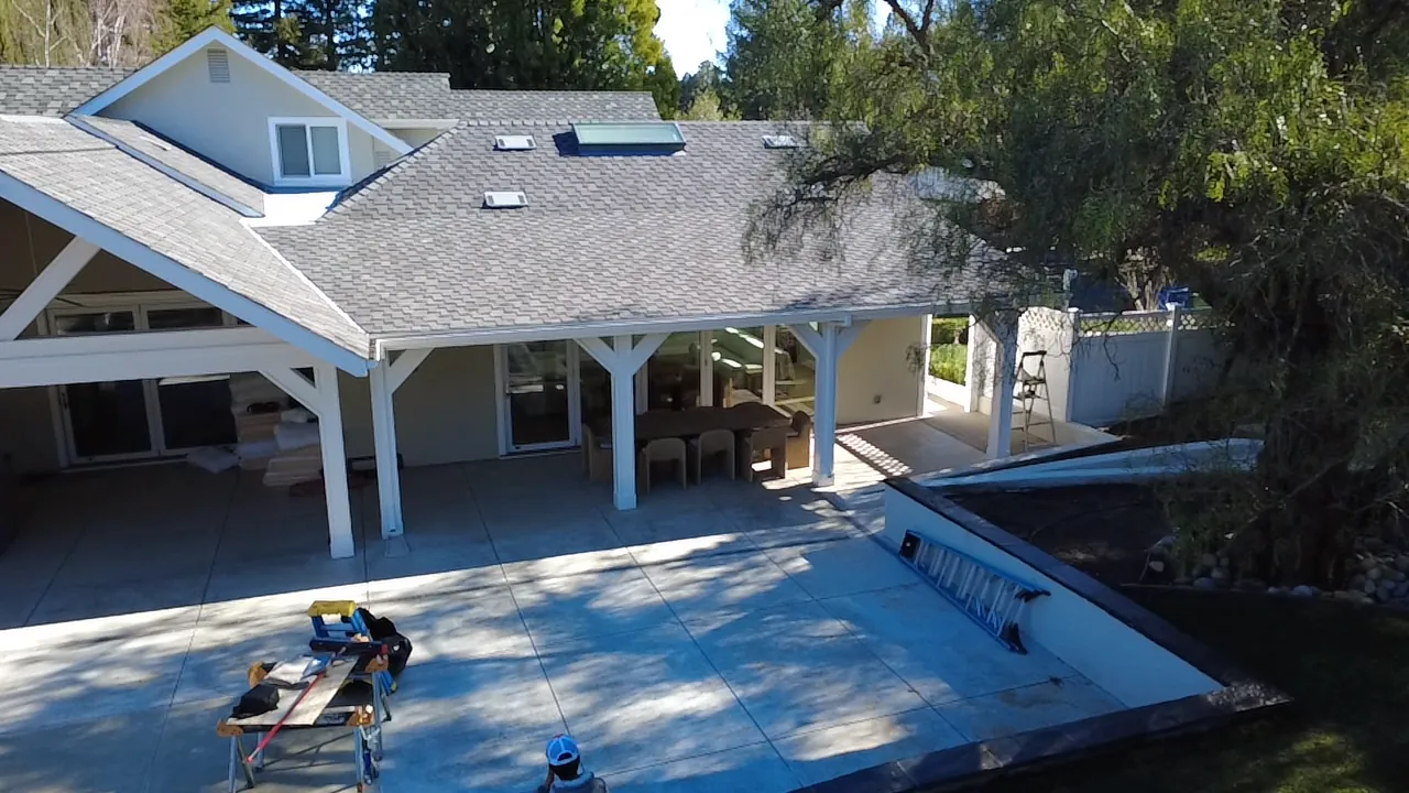 Backyard pavilion beside a pool during exterior work